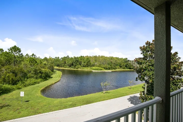 Large sliding glass doors in the Living and Dining areas frame PEACEFUL POND VIEWS, bringing the outdoors in and creating a serene backdrop to everyday living.