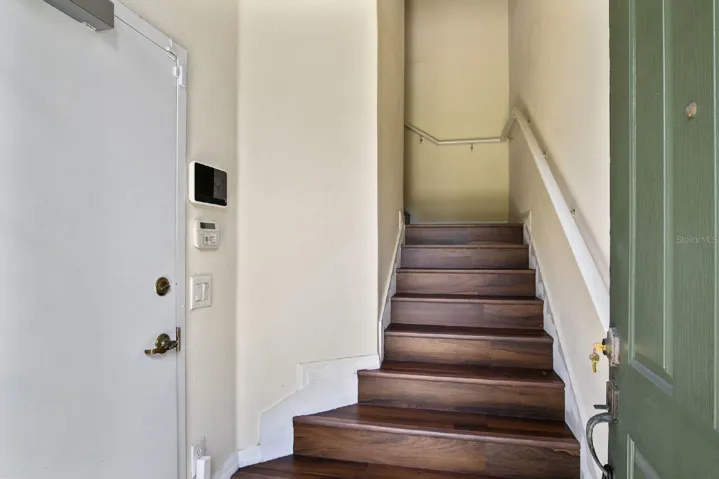 This two-story residence features a PRIVATE GARAGE on the first floor, with the main living space thoughtfully situated upstairs for added privacy and ELEVATED POND VIEWS.