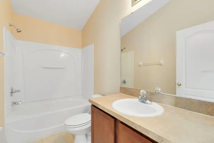 A second SPACIOUS BEDROOM is conveniently located near the additional full bath, ideal for guests, family, or a home office setup.
