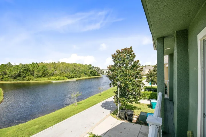 Large sliding glass doors in the Living and Dining areas frame PEACEFUL POND VIEWS, bringing the outdoors in and creating a serene backdrop to everyday living.