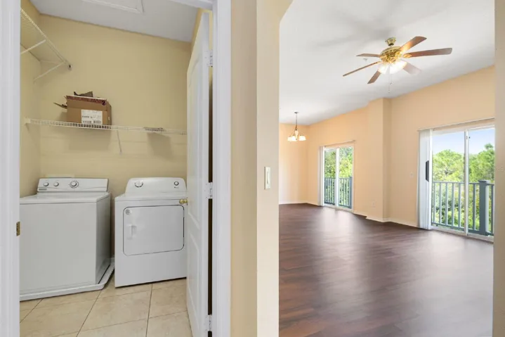 A convenient Laundry Room just off the Kitchen is complete with a washer/dryer and shelving for storage.