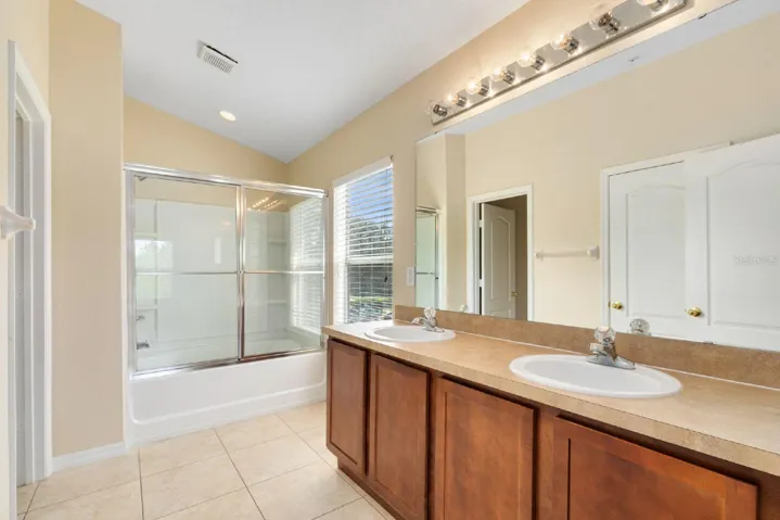 The EN SUITE BATH features dual sinks, a tub/shower combination, and a private water closet.