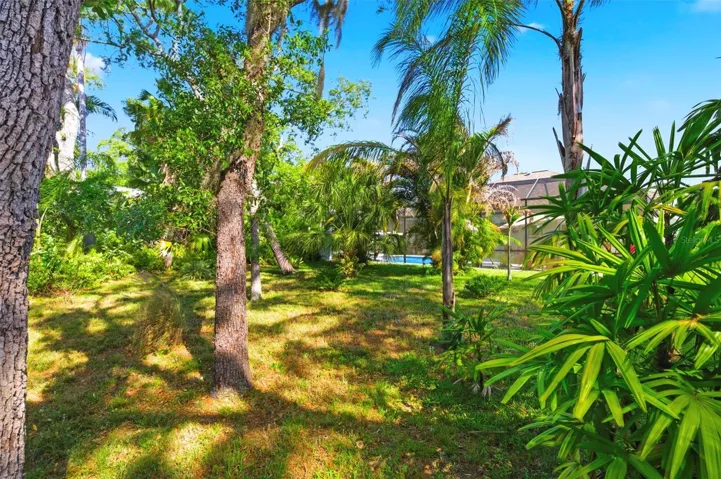 Expansive screened-in lanai offers an ideal outdoor living space with extended seating areas perfect for relaxing or entertaining. Enjoy the privacy and peaceful setting of a backyard that backs to a conservation area, providing serene views and no rear neighbors. This thoughtfully designed space allows you to fully embrace Florida living year-round.