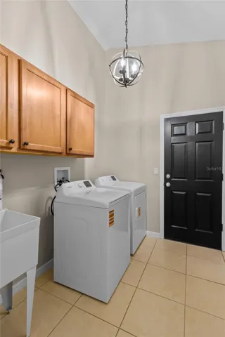Inside Laundry Room, w Utility sink at Garage Entrance.