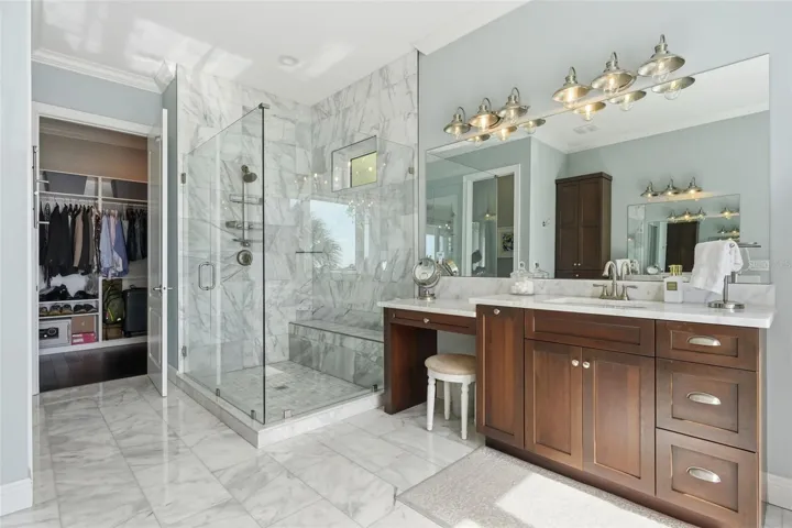 Master bedroom suite bathroom with oversized shower, two separate vanities + makeup vanity. The walk-in closet in the background is also spacious and phenomenal.