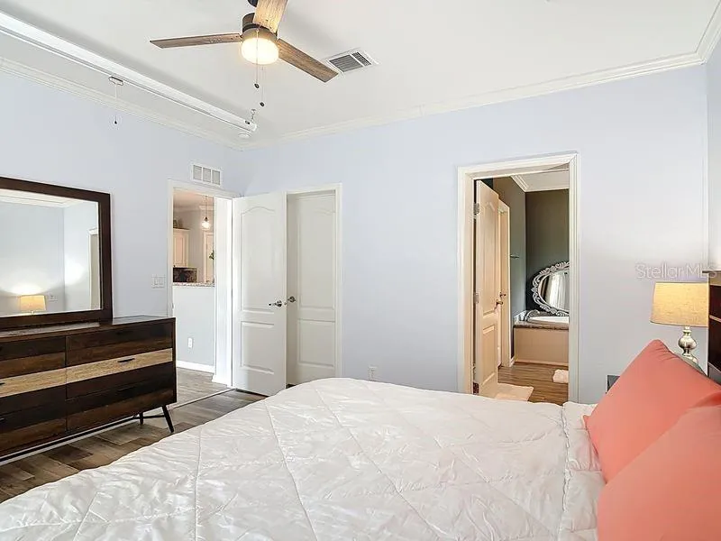 Primary bedroom with door, closet and bathroom