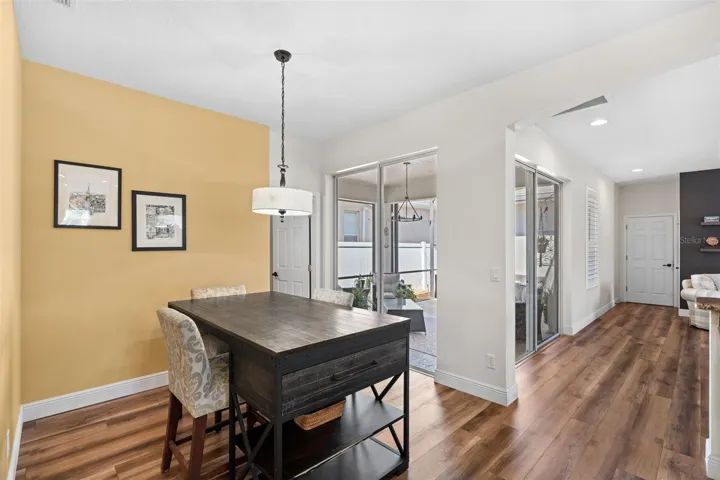 The SUNLIT BREAKFAST NOOK, framed by sliding doors, invites you to enjoy morning coffee with views of the outdoor living space.