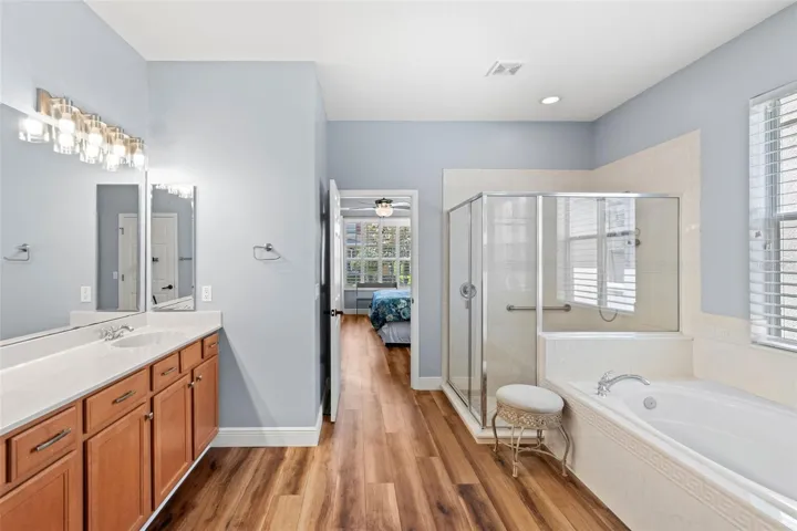 The Primary EN SUITE BATH boasts dual vanities, a soaking garden tub, a step-in shower, and a spacious walk-in closet.
