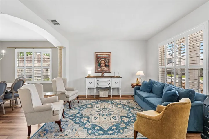 Step through the DECORATIVE GLASS-PANELED ENTRY into a light-filled interior adorned with PLANTATION SHUTTERS throughout and rich ARCHITECTURAL DETAILING, creating an atmosphere that feels both elevated and welcoming.