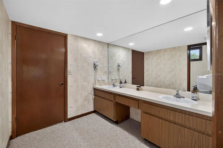 Large bathroom with dual sinks, generous vanity space, and vintage character.