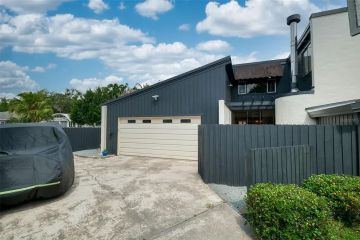 Side driveway and garage view showing additional parking.