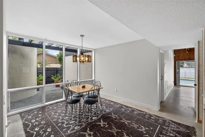 Dining area with convenient pass-through to the kitchen and great flow for everyday living. View of the courtyard.
