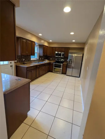 Large Country Kitchen with modern appliances and tiled floor.  Kitchenfeatures a huge pantry.  Big enough for a kitchen table!!