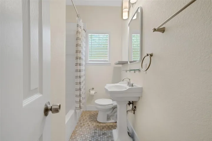 Bathroom #2 features a dedicated tub shower with tile surround.