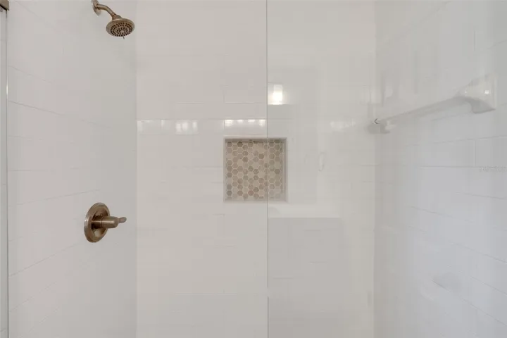 The glass enclosed shower was built for easy maintenance