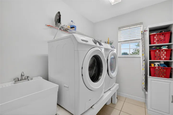 Upstairs laundry room with utility sink