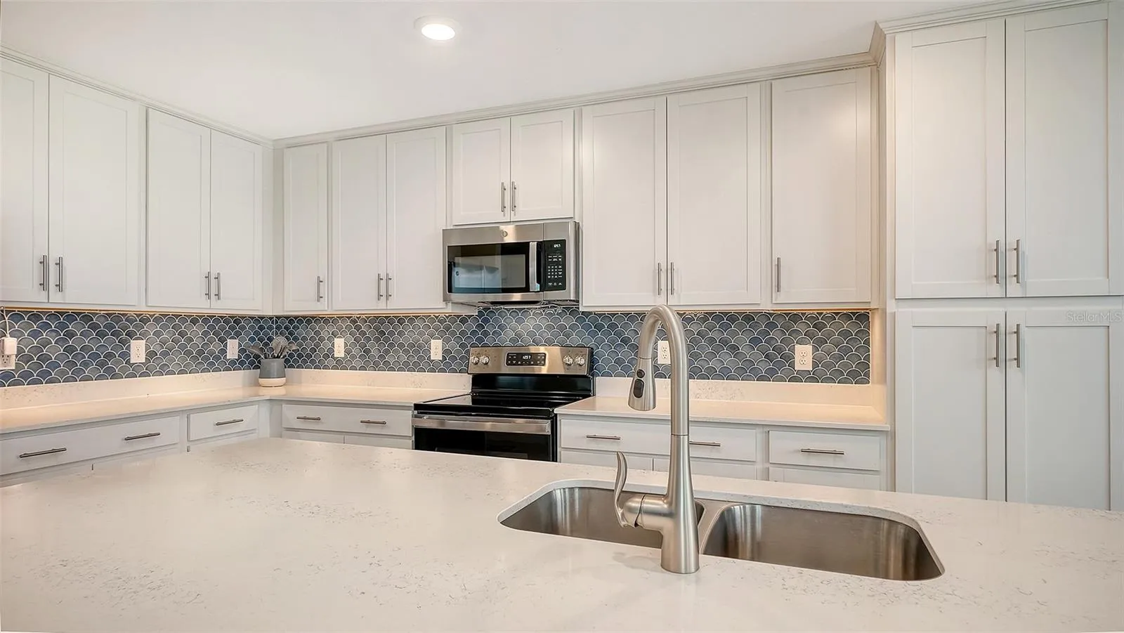 Gleaming backsplash with under cabinet lighting