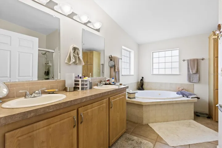 ensuite bath with whirlpool tub and double shower and dual sinks