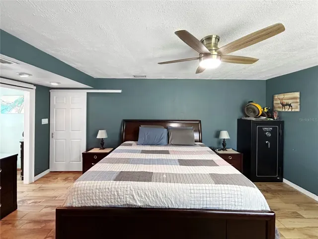 master bedroom staged with furniture vacant now.
