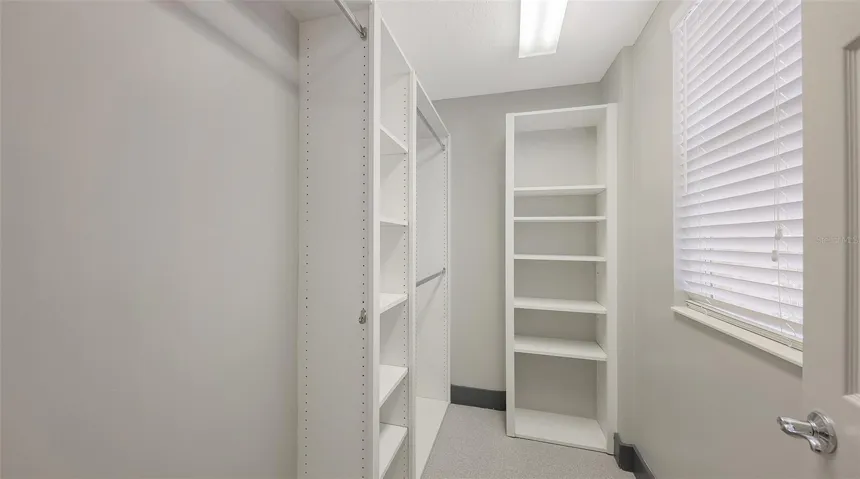 Walk-in closet for the first-floor primary bedroom.