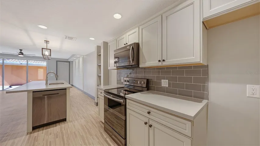 Solid wood cabinets, quartz counter tops and tile backsplash.