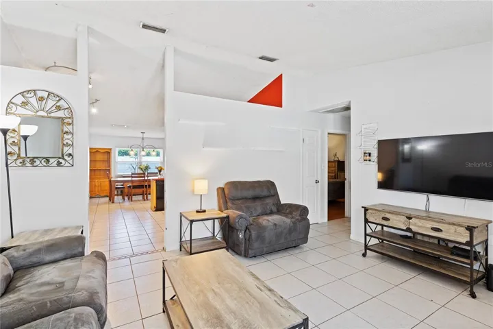 Living room leads into kitchen dining combo with additional storage closet