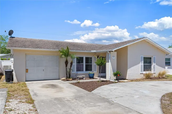 Front of home with rain gutters. Garage has been converted into front storage and 4th bedroom