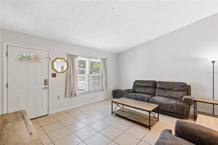Living room with small coat closet by front door