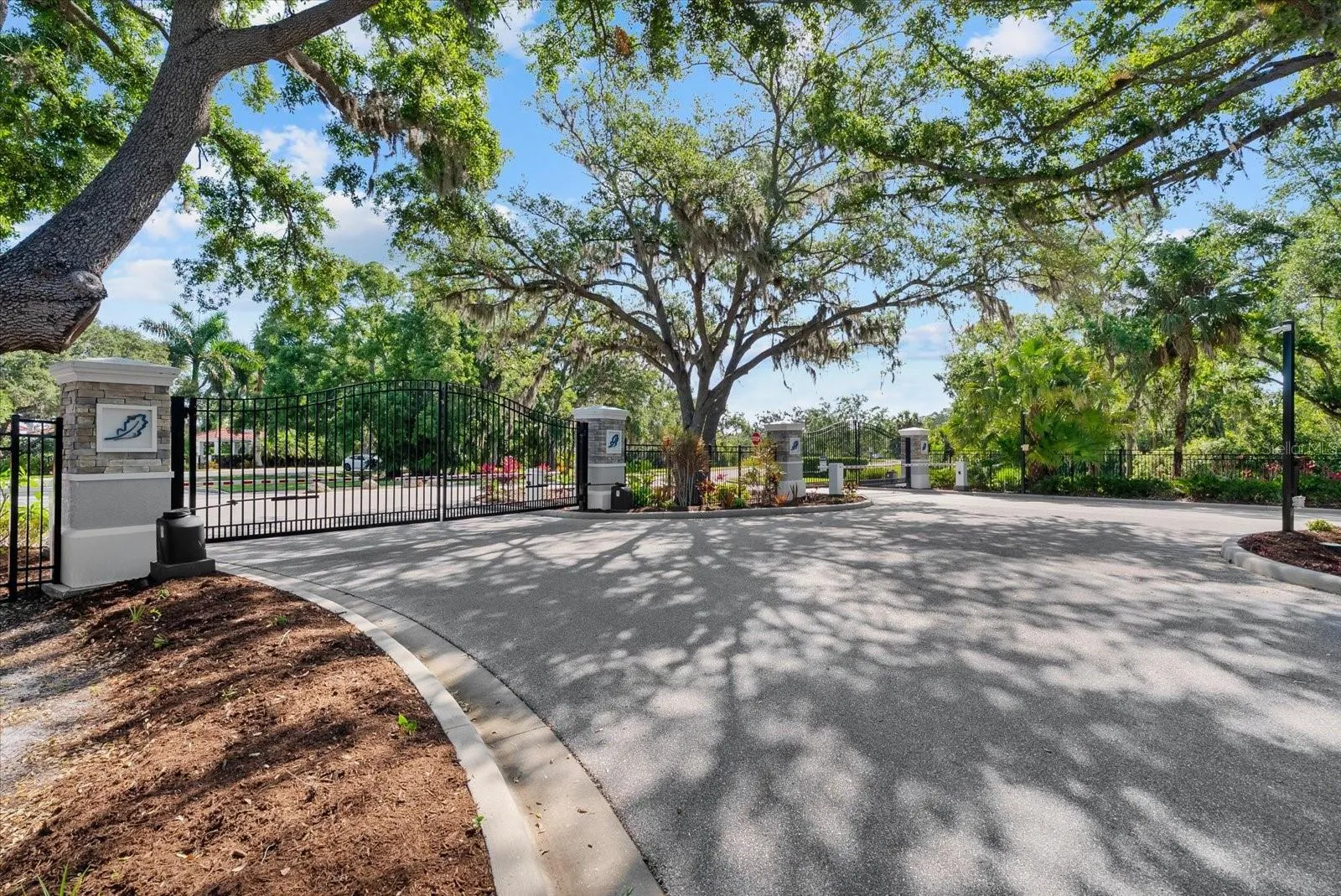 Gated community with oak tree canopy entry