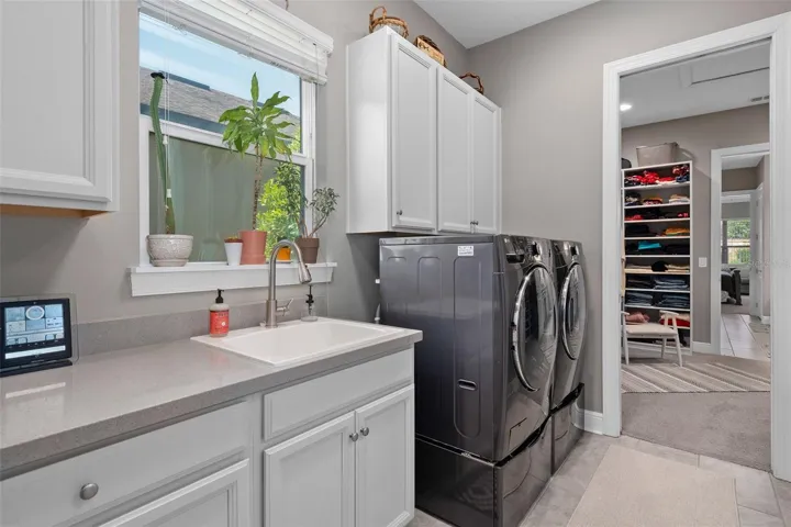 Laundry Room with a Sink, Built-in Broom Closet and Many More Cabinets