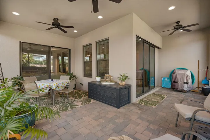 The Screened Lanai is Upgraded with Pavers, Exterior Power Roll Down Shades, a Gas Stub for your BBQ Grill and 3 Ceiling Fans