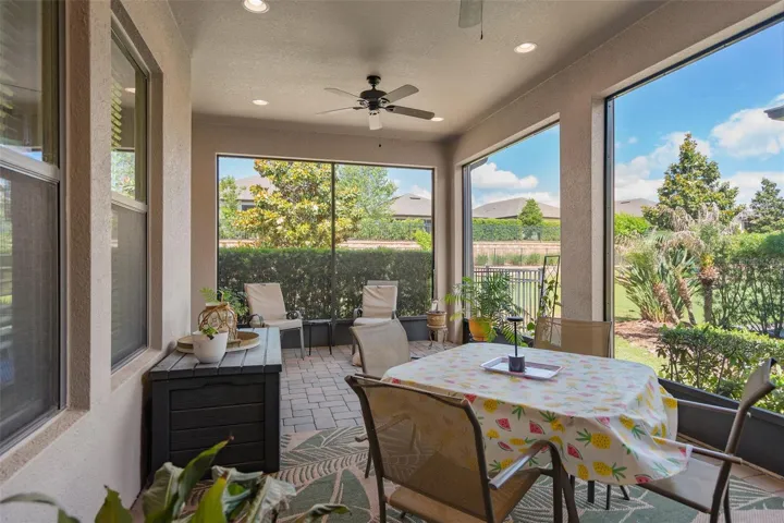 Spacious Under Roof Screened Lanai with Exterior Mounted Power Roll Down Shades