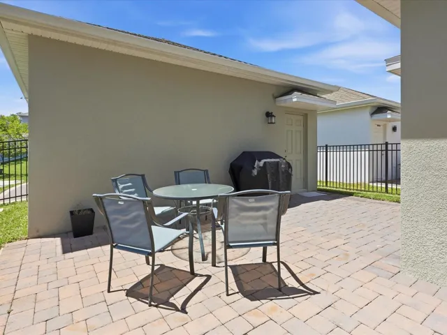Paved space between the house and garage -fenced
