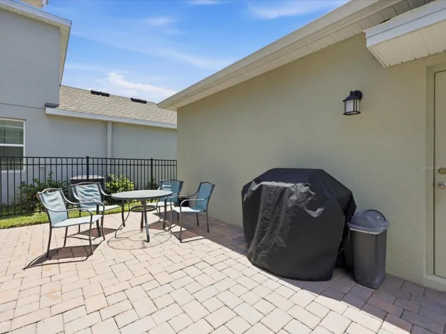 Paved space between the house and garage - fenced