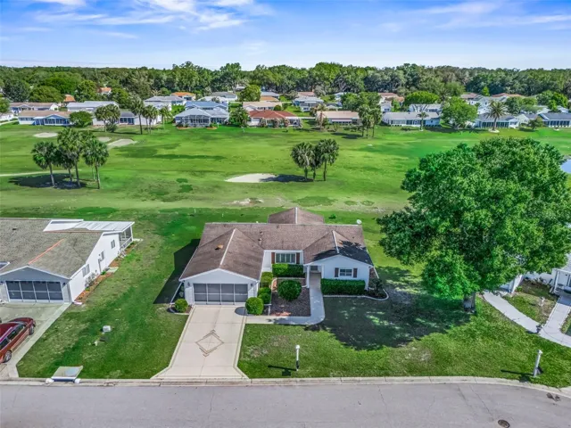 Front elevation of this lovely 3 bedroom, 2 bath home nestled on a private homesite with fabulous golf course and water views in Spruce Creek South.