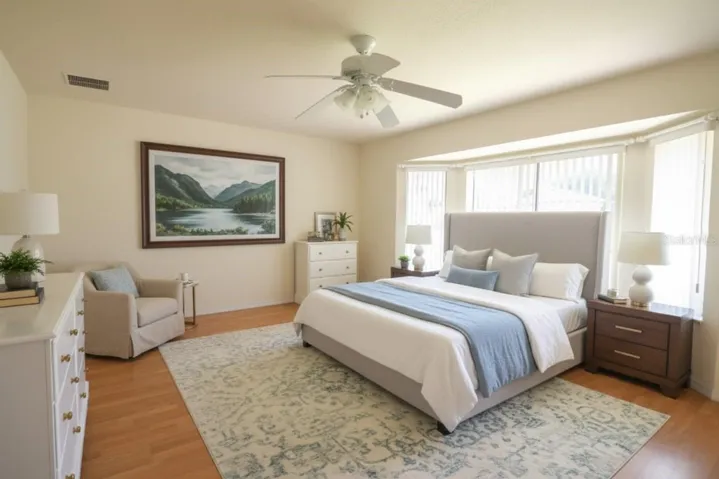 Staged Master Bedroom with Bay Windows & Laminate Flooring