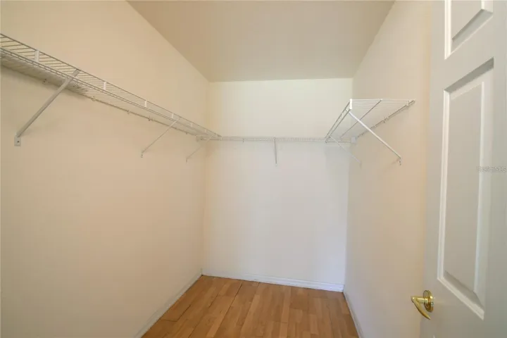 Master Walk-In Closet with Laminate Flooring