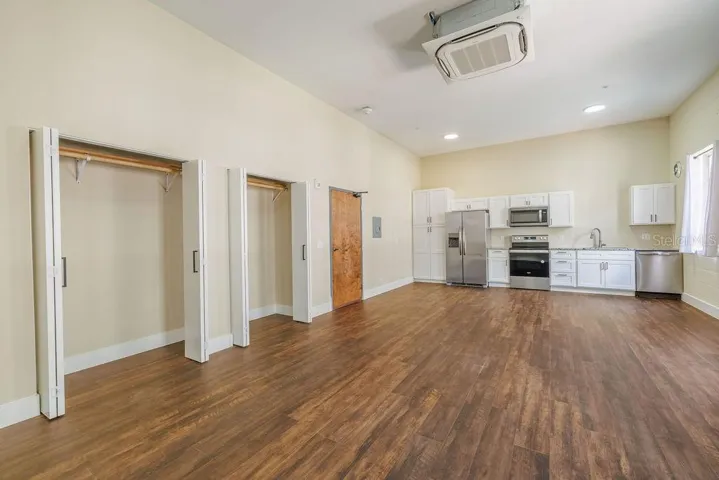 View from Northeast corner of kitchen, dual closets and front door.