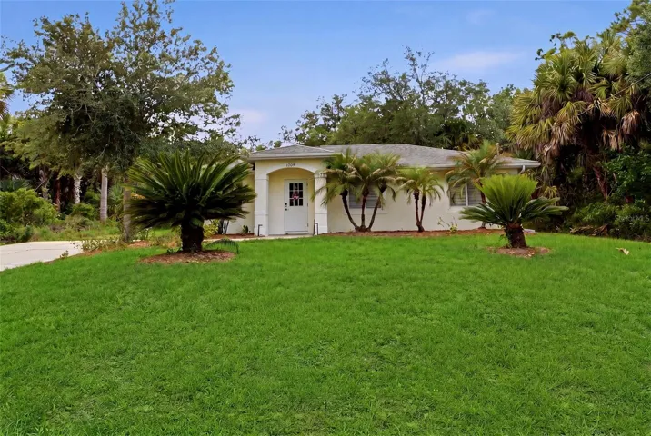 Front elevation with spacious lawn and established greenery