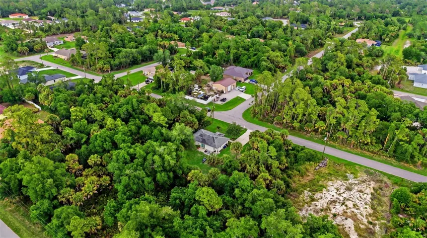 Neighborhood aerial showing nearby homes and streets