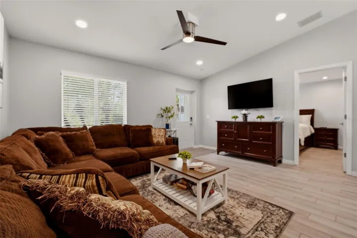 Spacious main living area with ceiling fan and neutral tones
