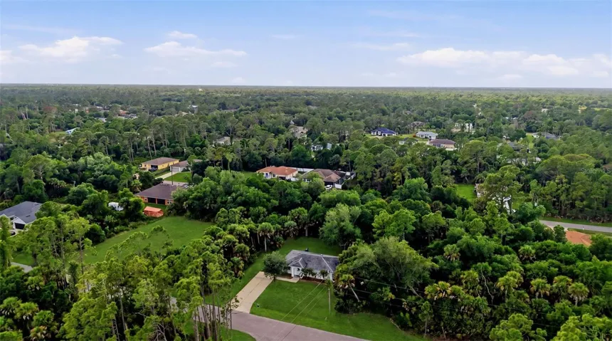 Aerial view showcasing surrounding area and greenery