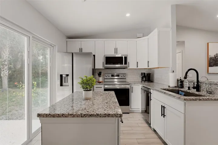 Updated kitchen with modern cabinetry and countertops