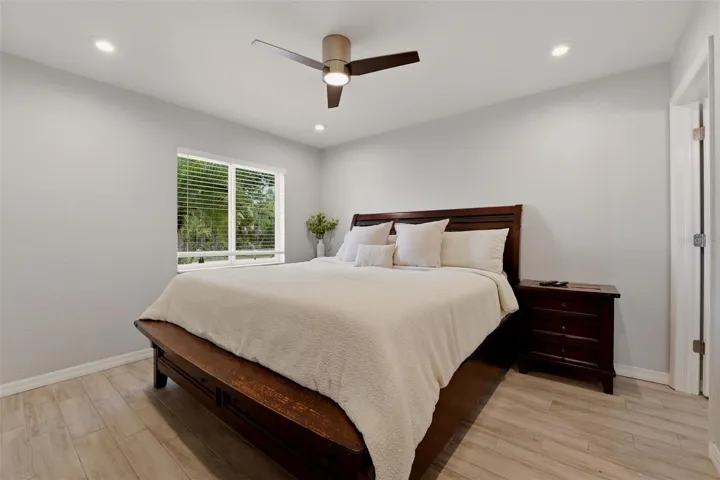 Primary bedroom with natural light and ceiling fan