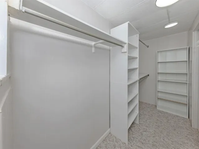 Primary bedroom walk-in closet