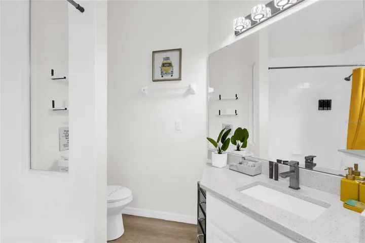 Updated bathroom with quartz countertops and modern fixtures