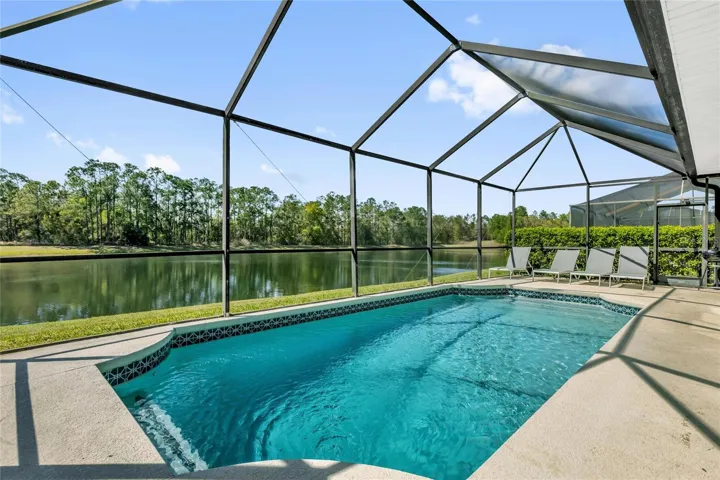 Private screened pool overlooking serene lake—perfect for relaxing and entertaining