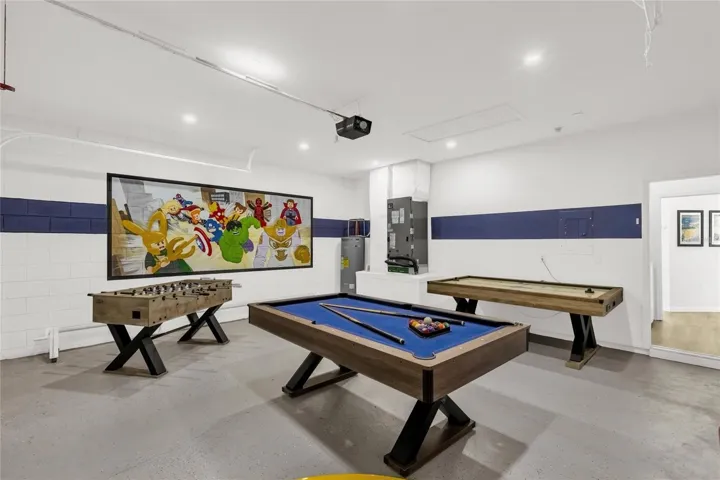 Spacious game room featuring billiards, foosball, and shuffleboard—perfect for entertaining guests or enjoying a fun night in