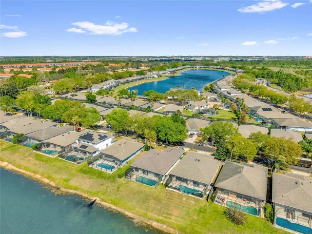 Stunning aerial view showcasing the peaceful lake setting and well-maintained surrounding community