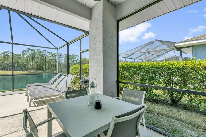 Covered lanai space ideal for outdoor dining and relaxation, with peaceful lake views and plenty of room for entertaining guests